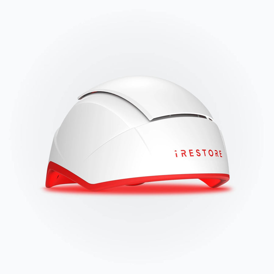 White iRESTORE Professional hair therapy helmet with red inner light, shown at an angle