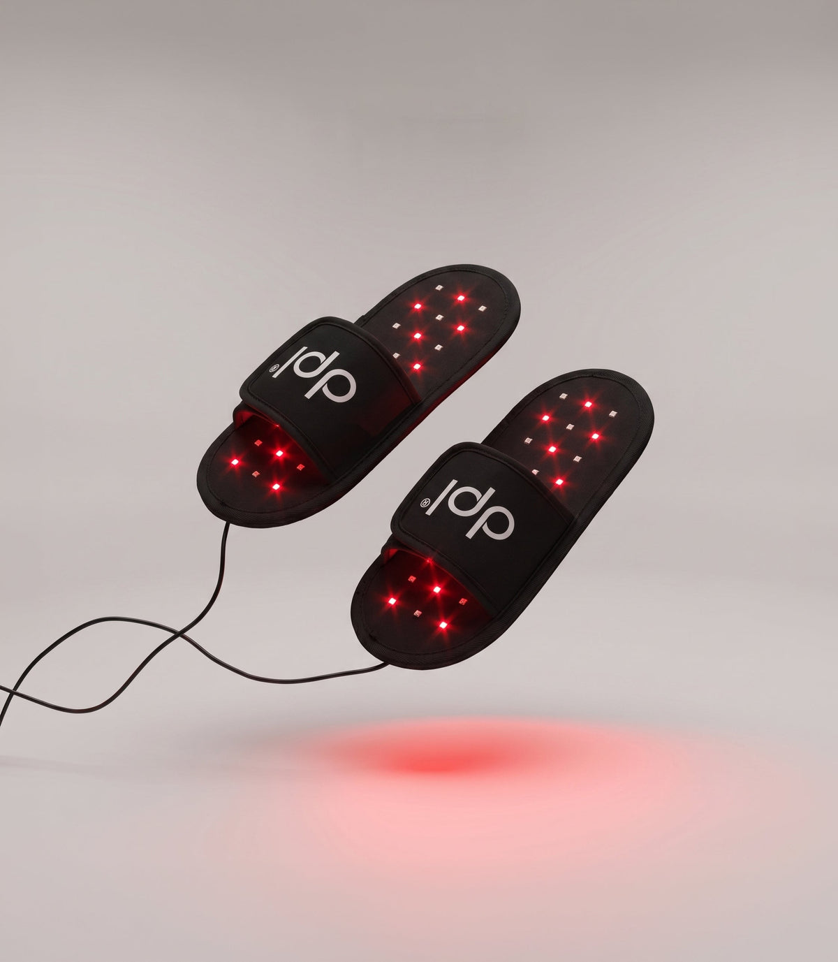 Pair of dpl light therapy slippers with illuminated inner surfaces and power cords